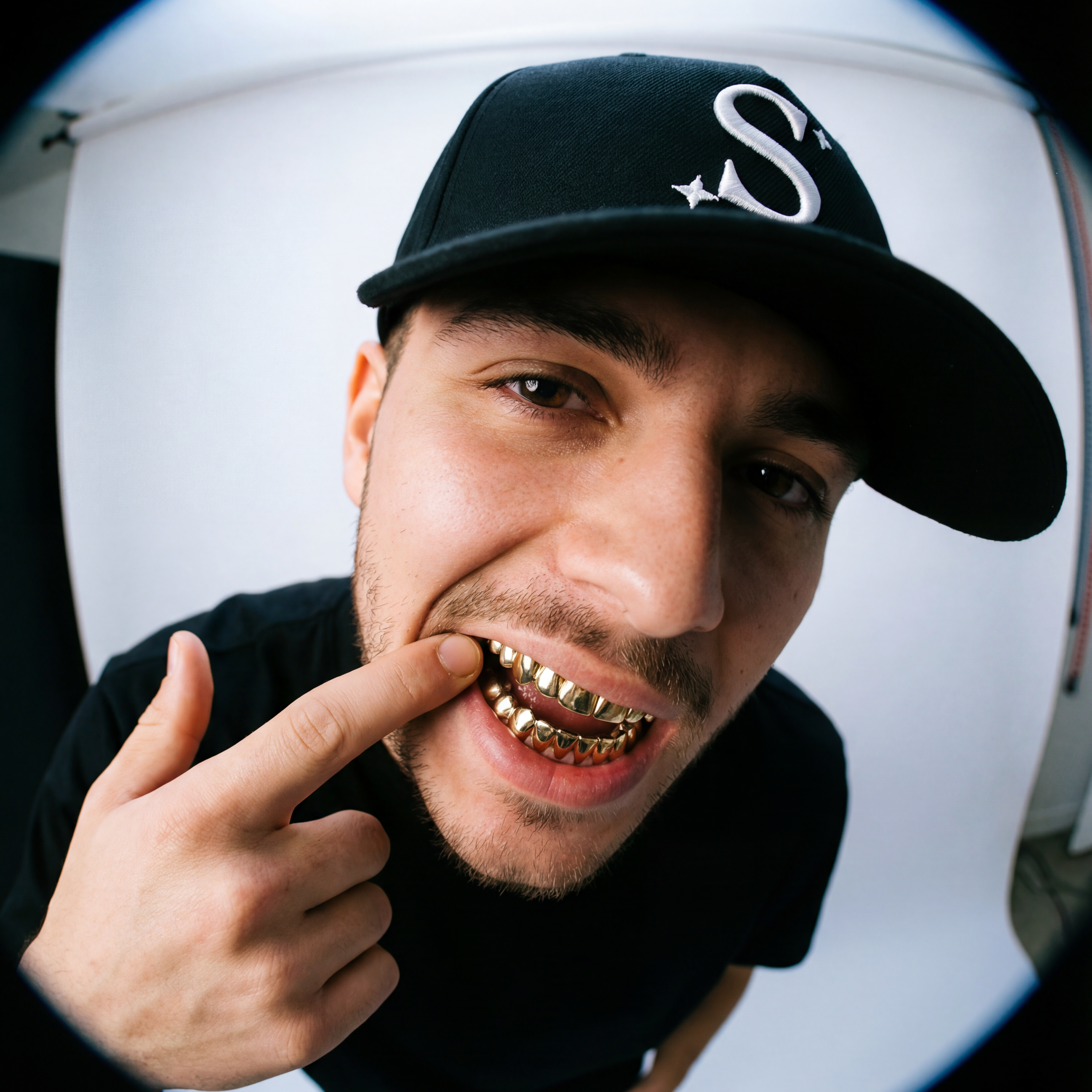 Man wearing a black trucker cap with a logo