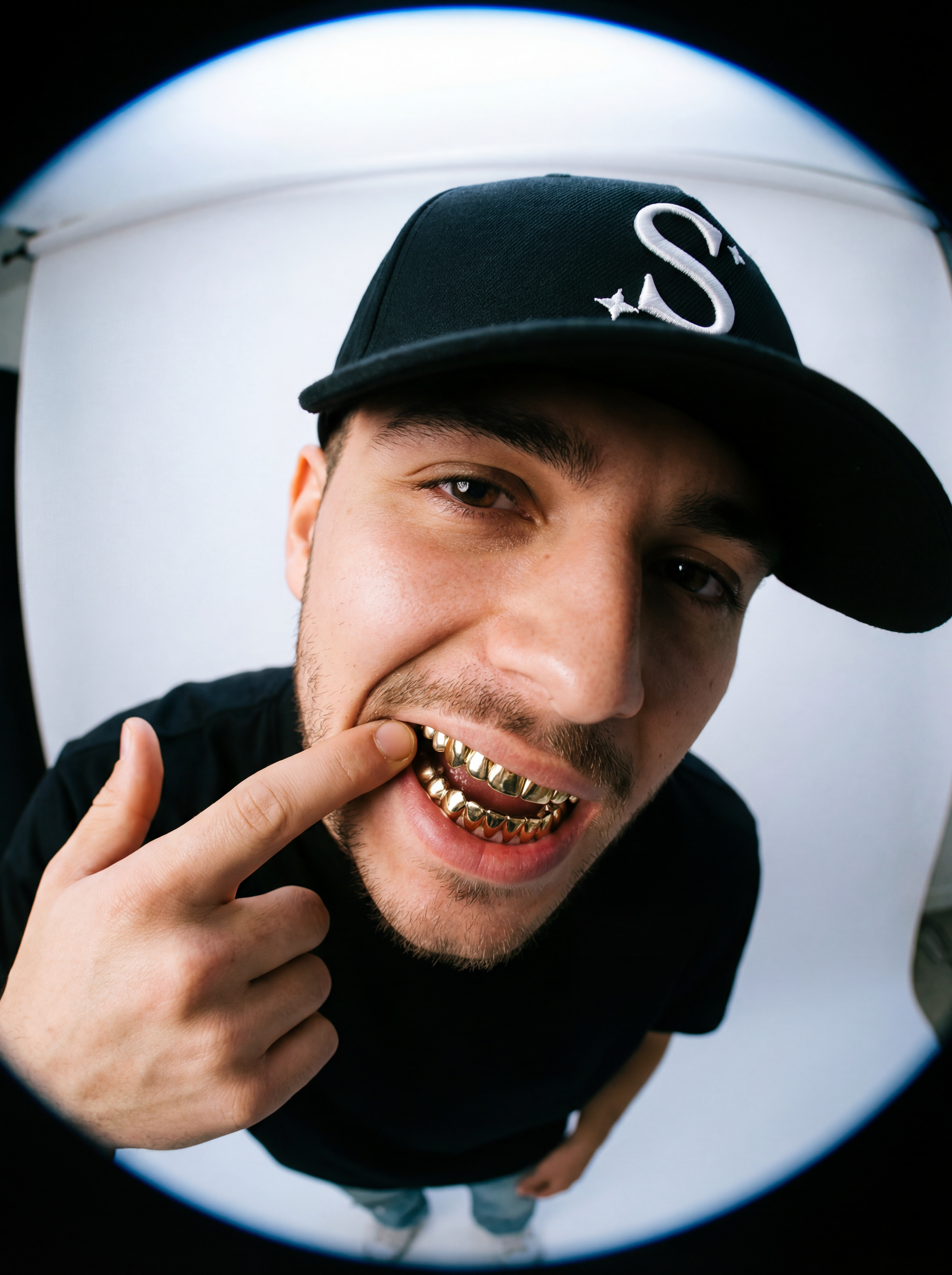 Man wearing a black trucker cap with a logo