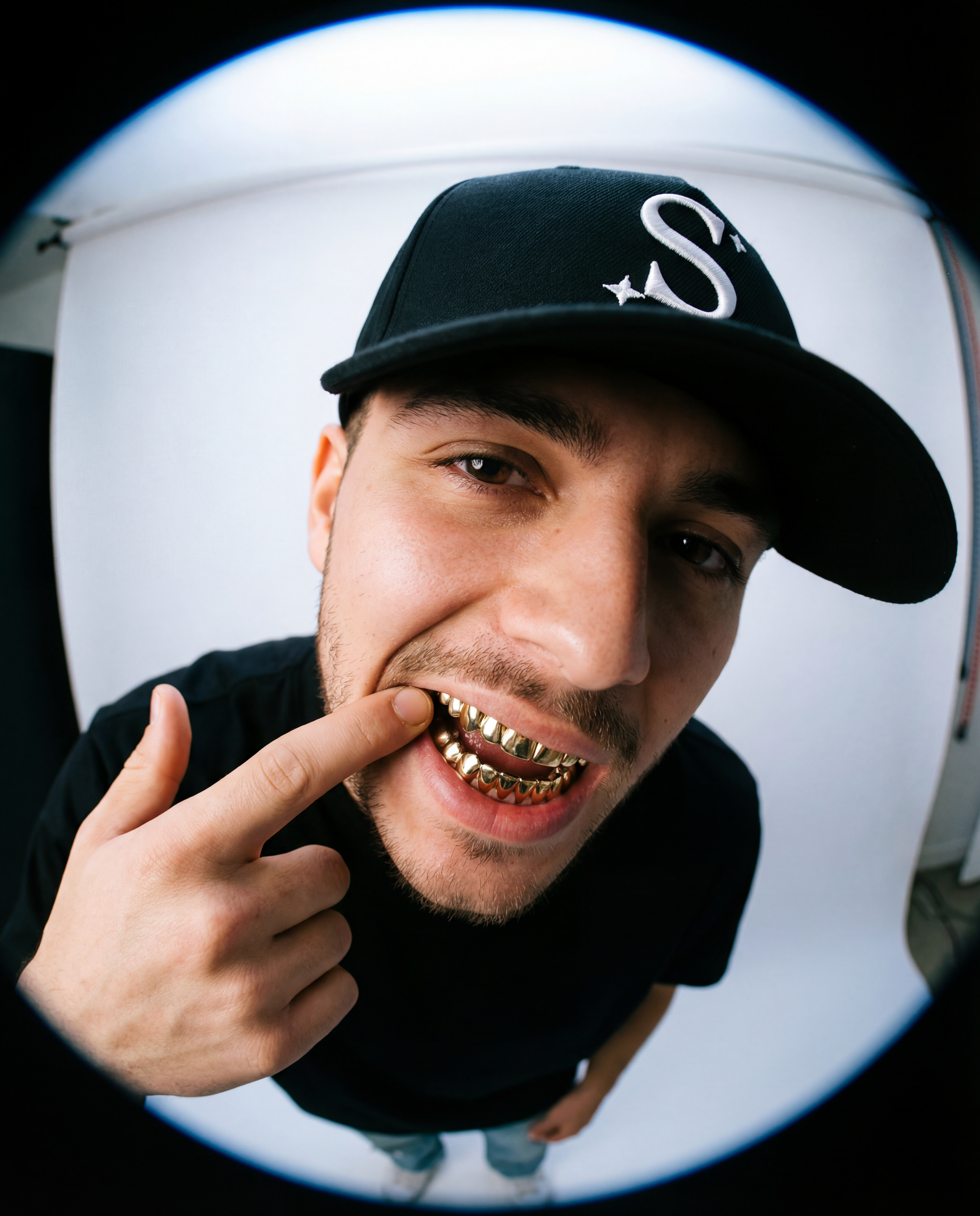 Man wearing a black trucker cap with a logo
