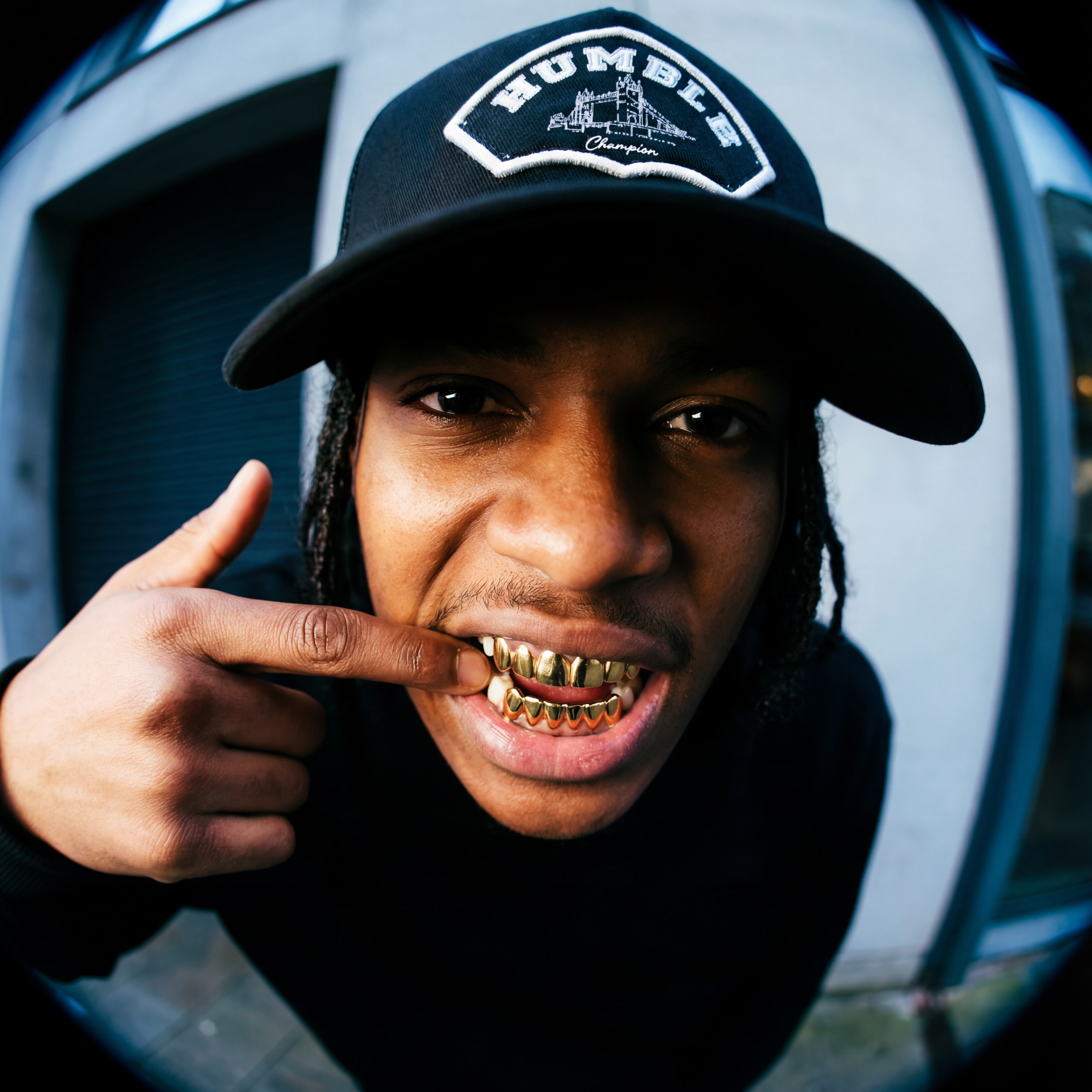 Person wearing a grey trucker cap with 'Humble' logo