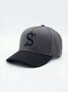 Grey trucker cap with a black 'S' logo