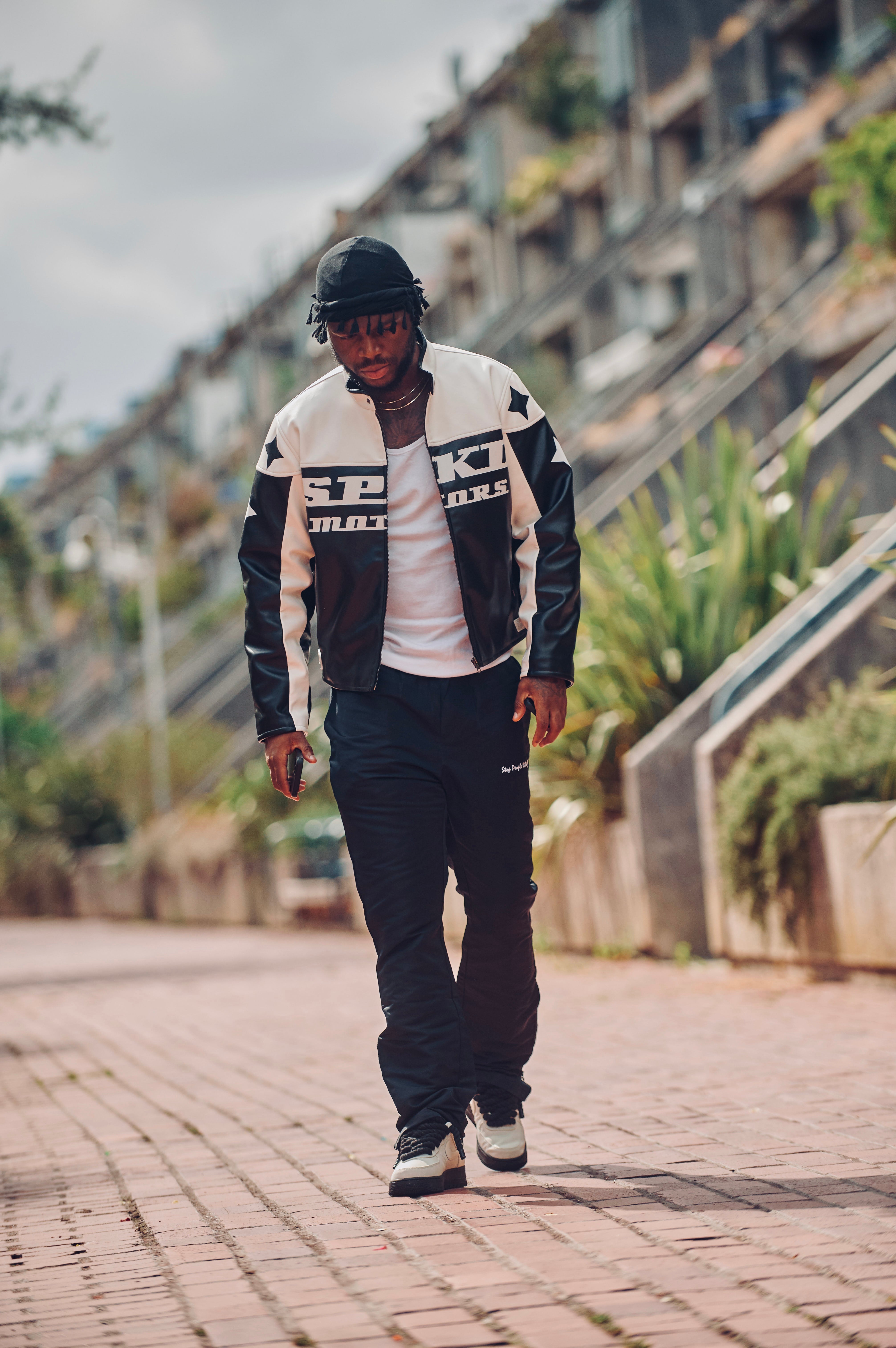 Black and white biker jacket big logo in front reading spkd motors, stars on sleeves