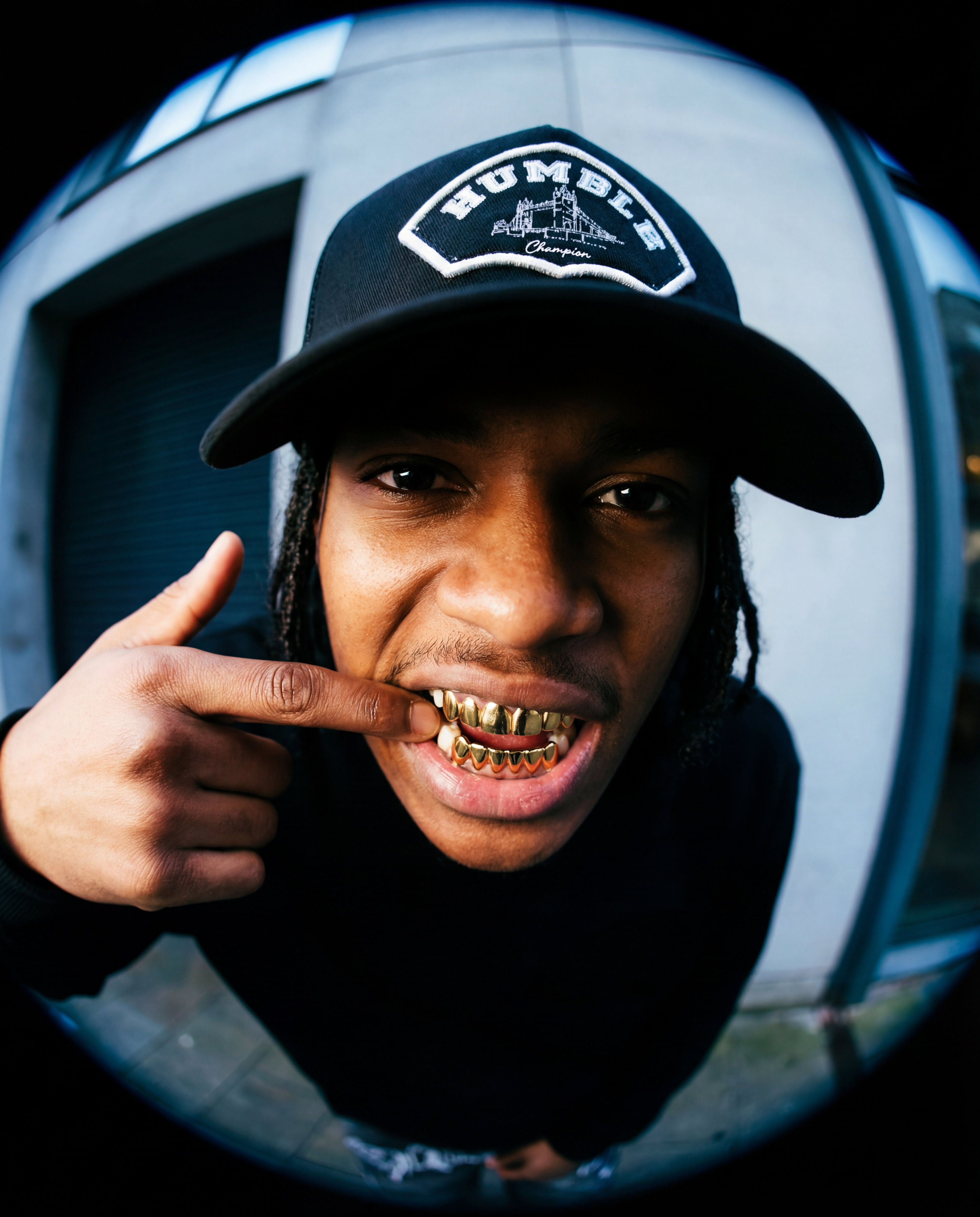 Person wearing a grey trucker cap with 'Humble' logo